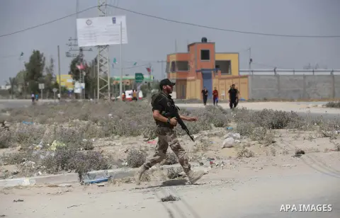 A Palestinian police holds back protesters from reaching the Erez crossing between Israel and the northern Gaza Strip June 7, 2013. The protest was part of the Global March to Jerusalem initiative, marking the 46th anniv...