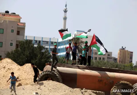 Palestinians gather during a protest near the border between Israel and the northern Gaza Strip June 7, 2013. The protest was part of the Global March to Jerusalem initiative, marking the 46th anniversary of Israel's cap...