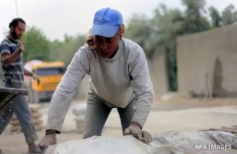 Palestinian woman Jamela Abu Esheba, 39, fills bags with cement at a work field in the northern Gaza Strip June 8, 2013. Abu Esheba, who lives with her aged parents, works as a cement bag porter and is the sole breadwinn...