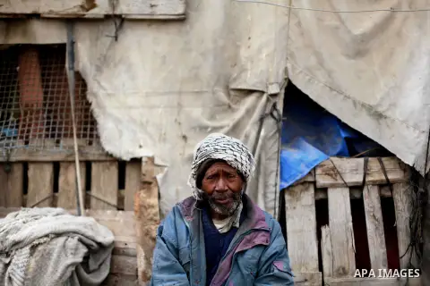 Atteya Abu Esheba. father of Palestinian woman Jamela Abu Esheba, poses for a photograph outside his dwelling in the northern Gaza Strip May 12, 2013. Jamela, who lives with her aged parents, works as a cement bag porter...