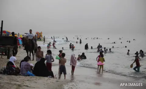 Palestinians enjoy swimming on the beach during sunny day in Gaza city on June 08, 2013. Photo by Ashraf Amra