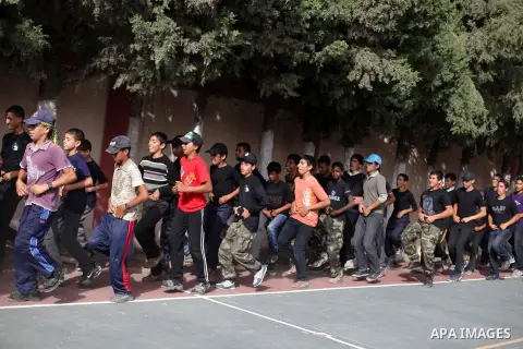 Palestinian youths take part in a summer camp organized by the Islamic movement of Hamas in Deir al-Balah in central of Gaza Strip, June 09, 2013. The Islamist movement Hamas is holding summer camps throughout the Gaza S...