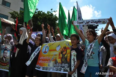 Palestinian children hold banners during a protest outside Red Cross office in Gaza City, on June 10, 2013 in solidarity with Palestinian prisoners held by Israel to demand their release from detention without trial. Pho...