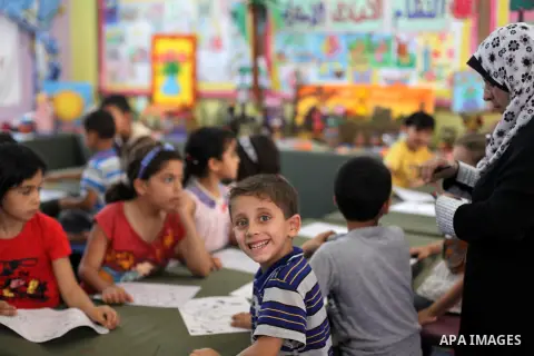 Palestinian children draw paintings at an entertainment center during the summer holiday in Gaza city June 11, 2013. Entertainment and educational institutions in Gaza strip focus on various activities for children durin...