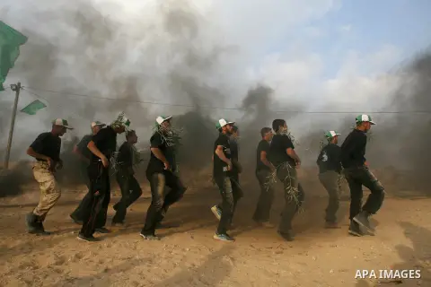 Young Palestinians take part in a summer camp organized by the Islamic movement of Hamas during the youngsters' summer school vacation in Rafah town, in the southern Gaza Strip, on June 12, 2013. The Islamist movement Ha...