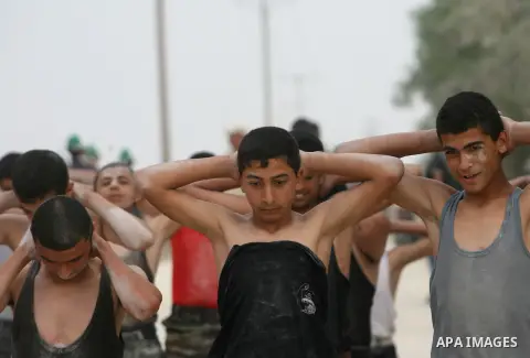 Young Palestinians take part in a summer camp organized by the Islamic movement of Hamas during the youngsters' summer school vacation in Rafah town, in the southern Gaza Strip, on June 12, 2013. The Islamist movement Ha...