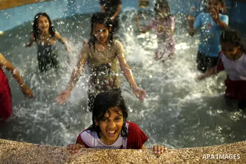 Palestinians play inside a swimming pool at al-Nour resort in Gaza City June 12, 2013. Al-Nour resort was established on the land of former Jewish settlement of Netzarim where it is open for free for the families of Pale...