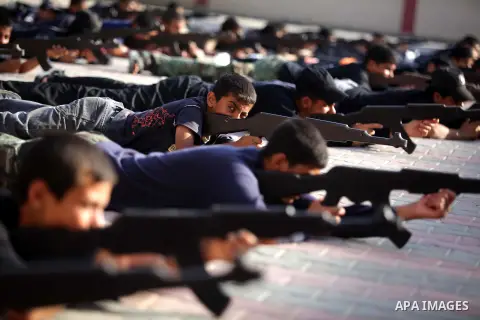 Young Palestinians show their skills during a summer camp graduation ceremony organized by the Islamic movement of Hamas in Deir al-Balah in central of Gaza Strip, June 13, 2013. The Islamist movement Hamas hold summer c...