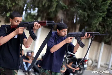 Young Palestinians show their skills during a summer camp graduation ceremony organized by the Islamic movement of Hamas in Deir al-Balah in central of Gaza Strip, June 13, 2013. The Islamist movement Hamas hold summer c...
