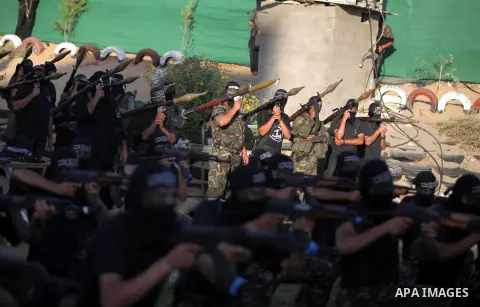Palestinian militants of the al-Nasser Salah al-Din Brigades, the military wing of the Popular Resistance Committees, participate in a military graduation ceremony in Gaza City June 13, 2013. Photo by Ashraf Amra