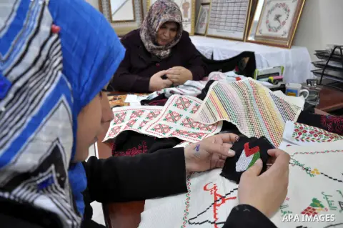 Palestinian wounded women work on embroidery at a training center of wounded women in Beit Lahia in northern Gaza Strip, June 16, 2013. Photo by Mohammed Talatene