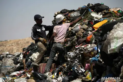Young Palestinians rummage through a garbage dump on the outskirts of Yatta, south of the West Bank city of Hebron, June 17, 2013. The boys reportedly scrounge through garbage to collect scrap metal and plastic that coul...