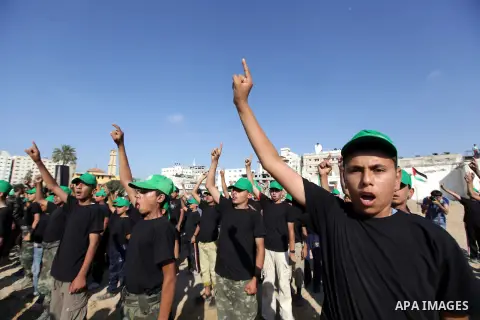 Young Palestinians take part in a military-style exercise during a summer physical training camp run by Islamic movement of Hamas in Gaza City on June 17, 2013. Photo by Ashraf Amra