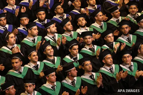 Palestinian students participate in their graduation ceremony at the University College of Applied Sciences in Gaza city on June 17, 2013. Photo by Mohammed Asad