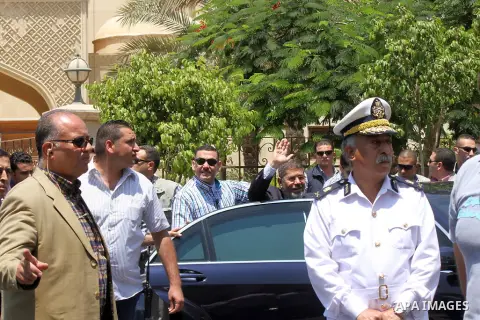 Egyptian President Mohammed Morsi waves to supporters following performing Friday prayers at al-Quds mosque, in Cairo on June 21, 2013. Tens of thousands of Egyptian Islamists gathered for a show of strength in Cairo ahe...