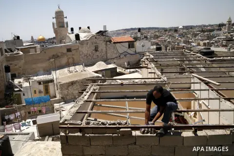 A Palestinian man from Hijazi family destroys his family home in Jerusalem's Old City on June 22, 2013. Monther Hijazi, 65, decided to demolish his own home to carry out an Israeli court order, following pay 40,000 sheke...