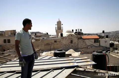 A Palestinian man from Hijazi family destroys his family home in Jerusalem's Old City on June 22, 2013. Monther Hijazi, 65, decided to demolish his own home to carry out an Israeli court order, following pay 40,000 sheke...