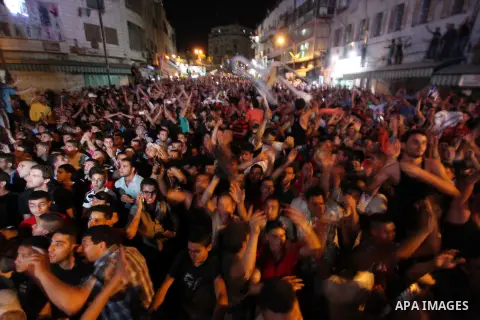 Palestinians celebrate after Palestinian singer Mohammed Assaf won a regional TV singing contest, in the West Bank city of Ramallah, Saturday, June 22, 2013. Palestinians relished a rare moment of pride and national unit...
