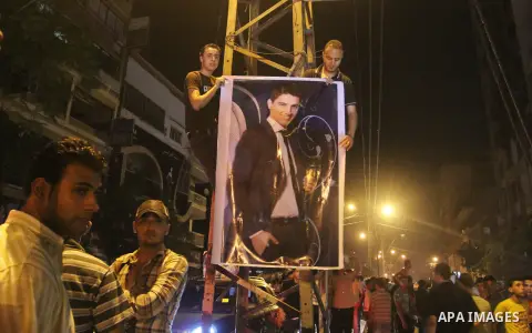 Palestinians celebrate after Palestinian singer Mohammed Assaf won a regional TV singing contest, in front of Assaf's home, Gaza City, June 22, 2013. Palestinians relished a rare moment of pride and national unity Saturd...