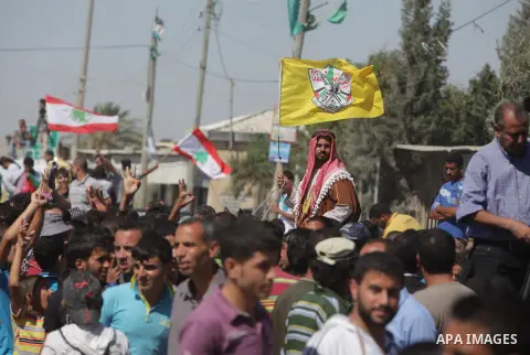 Palestinians wait for the Arab Idol winner Palestinian Mohammed Assaf, unseen, at the entrance of Rafah crossing point on the border between Egypt and southern Gaza Strip, Tuesday, June 25, 2013. Huge crowds of Gazans ga...