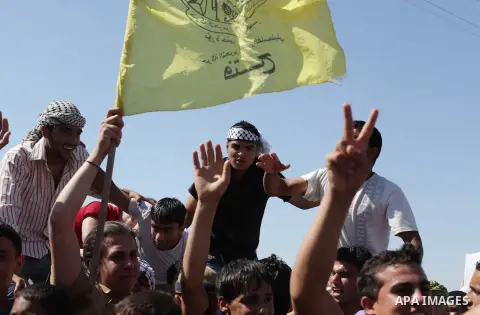 Palestinians wait for the Arab Idol winner Palestinian Mohammed Assaf, unseen, at the entrance of Rafah crossing point on the border between Egypt and southern Gaza Strip, Tuesday, June 25, 2013. Huge crowds of Gazans ga...