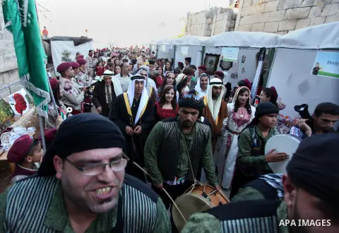 Palestinians take a part in a traditional wedding in the West Bank Town of Birzeit, near Ramallah during the Rozana Cultural Festival, June 26, 2013. Photo by Issam Rimawi