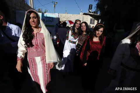 Palestinians take a part in a traditional wedding in the West Bank Town of Birzeit, near Ramallah during the Rozana Cultural Festival, June 26, 2013. Photo by Issam Rimawi