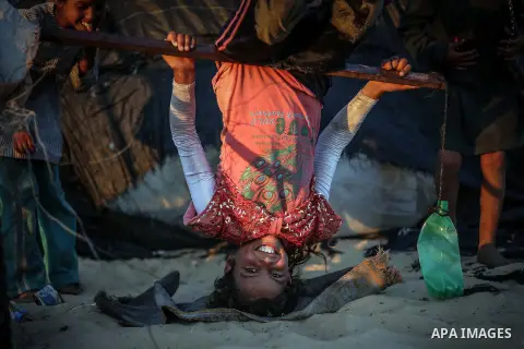 Palestinian children play outside their family's tent where they live in a poverty-stricken quarter of the town of Khan younis, in the southern Gaza Strip, 26 June 2013. Photo by Mahmoud Hamda