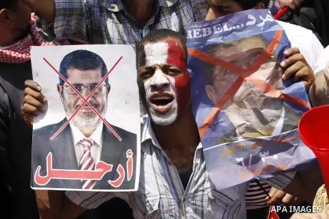 Protesters opposing Egyptian President Mohamed Mursi holds a sign during a protest at Tahrir square in Cairo June 30, 2013. Mass demonstrations across Egypt on Sunday may determine its future, two and half years after pe...