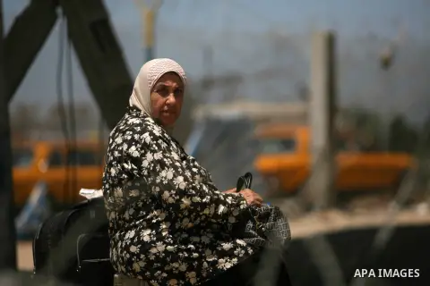 A Palestinian woman wates at the Rafah crossing with Egypt in the southern Gaza Strip on July 5, 2013. Egyptian police closed the Rafah border crossing with Gaza after Egyptian Islamist militants fired rockets and direct...