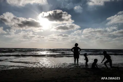 Tourists enjoy playing on the Mediterranean Sea in the Al-Naqoura area, southern Lebanon, near the Lebanese Israeli border, 05 July 2013. Al-Naqoura is a geologic formation, located on the coast of the Mediterranean Sea,...