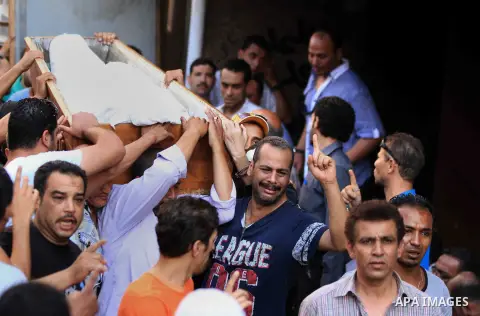 Egyptian people carry the coffins of some of the victims of the clashes that broke out the day before on July 6, 2013 during a funeral ceremony in the Cairo neighbourhood of al-Manial. The clashes broke out overnight in...