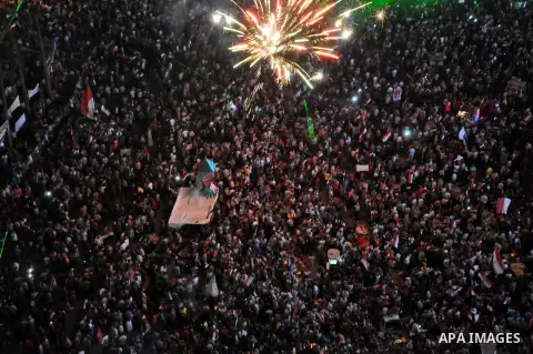 Fireworks light up the sky on July 7, 2013 as hundreds of thousands Egyptians flood Egypt's landmark Tahrir square to demontrate against ousted President Mohammed Morsi and in support of the Egyptian Army in Cairo. Oppon...