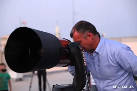 A Palestinian man scans the horizon for the crescent moon that will determine the beginning of the holy fasting month of Ramadan, in the West Bank city of Hebron, July 8, 2013. Muslims around the world will start observi...
