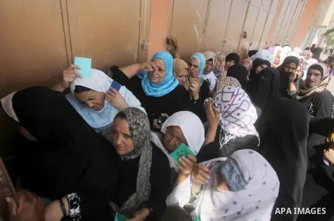 Palestinians receive their food aid from the charity in Deir al-Balah in central Gaza Strip, on July 9, 2013.as people prepare for the upcoming Muslim holy fasting month of Ramadan. Muslims around the world celebrate Ram...