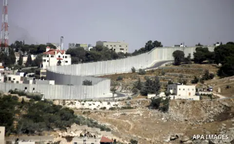 A picture shows a side of the Israeli separation wall arround Jerusalem on July 9, 2013. The Israeli Coordinator of Government Activities in the Territories (COGAT) announced in a press statement that Palestinian men and...