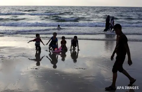 Palestinians enjoy swimming in the sea at Gaza beach on July 9, 2013.ahead of the Muslim holy fasting month Ramadan. Photo by Ashraf Amra