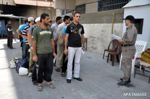 Palestinian prisoners wait to leave the prison run by the security forces in Gaza Strip, in Gaza City on July 10, 2013 Security officials in Gaza Strip said on Wednesday they released 65 criminal prisoners occasion of th...