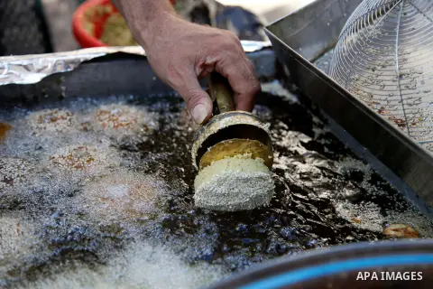 A Palestinian man prepares traditional Falafel during the first day of the holy fasting month of Ramadan, in Jerusalem on July 10, 2013. Photo by Saeed Qaq