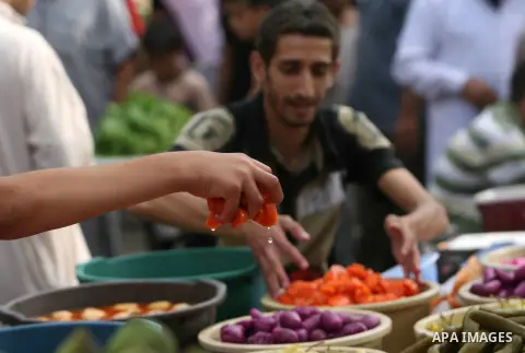 A Palestinian vendor sells pickles on the second day of the Muslim fasting month of Ramadan on July 11, 2013 in Rafah in southern Gaza strip. During Ramadan, one of the five main religious obligations under Islam, Muslim...