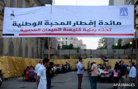 Egyptians gather for break their fast on the third day of Ramadan, in Tahrir Square, the focal point of protests against ousted President Mohammed Morsi, Friday, July 12, 2013 in Cairo. Elsewhere, tens of thousands of su...