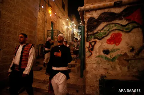 Palestinian dawn awakeners, al-Musaharati in Arabic, walk through streets to wake up Muslims for a meal before sunrise during the fasting month of Ramadan, in Jerusalem's old city on July 13, 2013. Al-Musaharati is an ol...