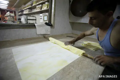 A Palestinian man prepares traditional sweets "Baklava" during the fourth day of the holy fasting month of Ramadan, in Jerusalem old city, on July 13, 2013. Muslims around the world are observing the holy fasting month o...
