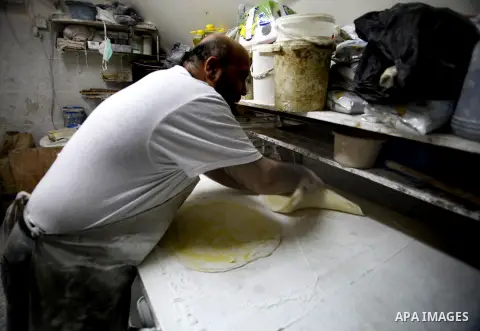 A Palestinian man prepares traditional sweets "Baklava" during the fourth day of the holy fasting month of Ramadan, in Jerusalem old city, on July 13, 2013. Muslims around the world are observing the holy fasting month o...