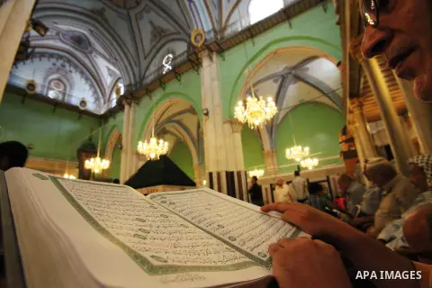 A Palestinian man reads Quran at a mosque during the holy fasting month of Ramadan, in the West Bank city of Hebron on July 14, 2013. During Ramadan, muslims around the world are observing the holy fasting month of Ramad...