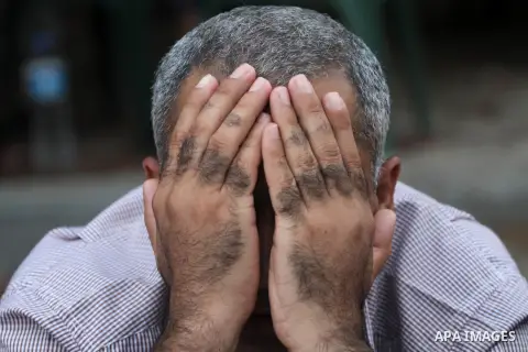 A Palestinian relative of prisoners in Israeli jails prays before eat the Iftar meal to break their fasting during a protest in front of Red Cross headquarter in Gaza city on July 14, 2013. Photo by Mohammed Asad