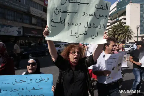 Palestinian protesters shout slogans during a demonstration against Israeli government's plans to relocate Bedouins in the Negev desert, on July 15, 2013, in the West Bank city of Nablus. Thousands of Bedouin marched dem...