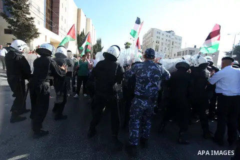 Palestinian protesters scuffle with policemen during a demonstration against Israeli government's plans to relocate Bedouins in the Negev desert, on July 15, 2013 near the West Bank town of Ramallah. Thousands of Bedouin...