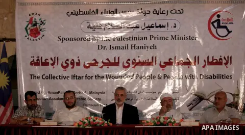 Palestinian Prime Minister in Gaza Strip Ismail Haniyeh attends the annual Iftar ceremony 'the evening meal during the Islamic month of Ramadan' to break his fasting with the injured and wounded Palestinians in Gaza city...