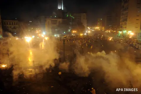 Supporters of deposed Egyptian President Mohamed Mursi run from tear gas fired by riot police during clashes on the Sixth of October Bridge over the Ramsis square area in central Cairo July 15, 2013. Police fired tear ga...
